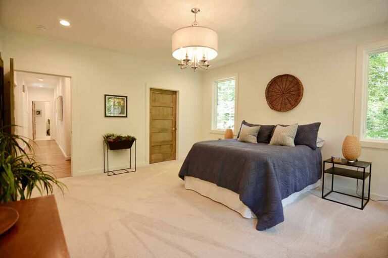 Bedroom in Durham, NC with recessed lighting and a chandelier installed by MSS Ortiz.