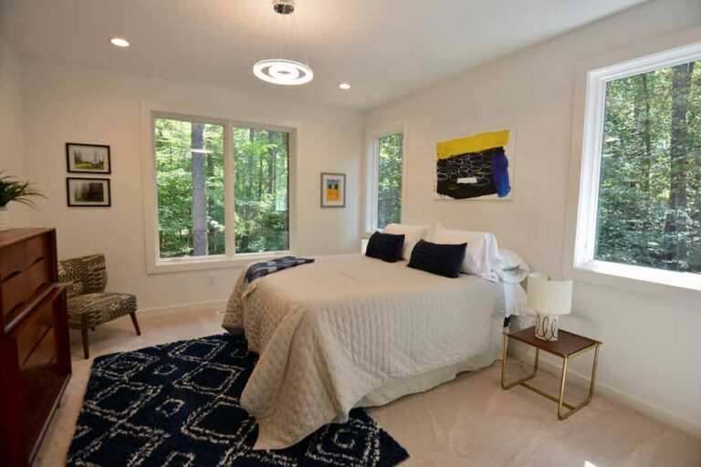 Bedroom with modern chandelier and recessed lighting fixtures by MSS Ortiz electricians in Durham.