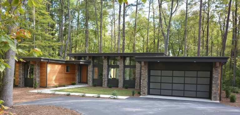 Exterior view of a home in Durham, NC that has a garage with outdoor lighting above the entrance.