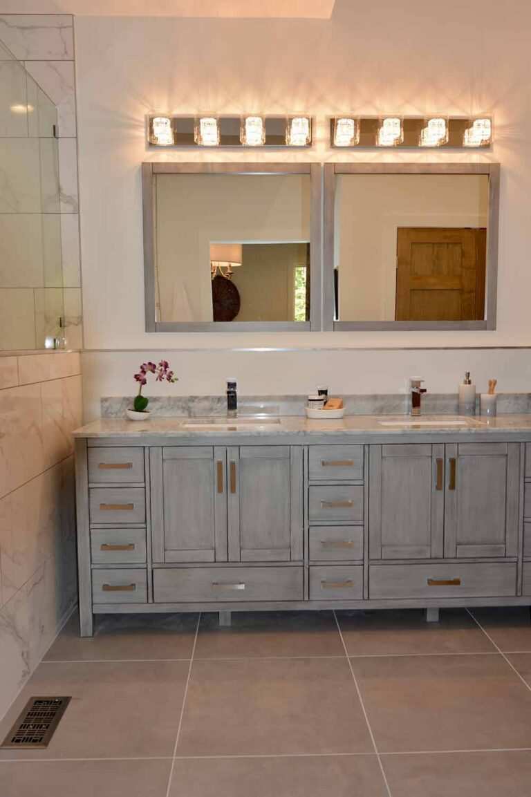 His and hers bathroom vanity with uplighting done by MSS Ortiz electricians in Durham, NC.