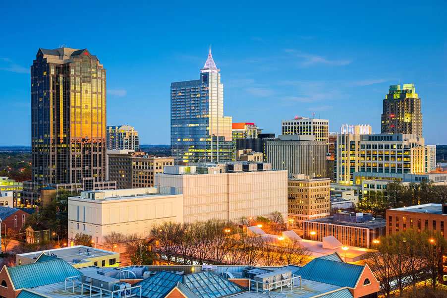 Raleigh, NC skyline with lit buildings whose commercial electrical services were done by MSS Ortiz.