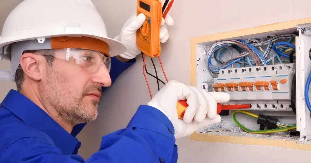 A man performing a circuit breaker installation after learning how to install a circuit breaker